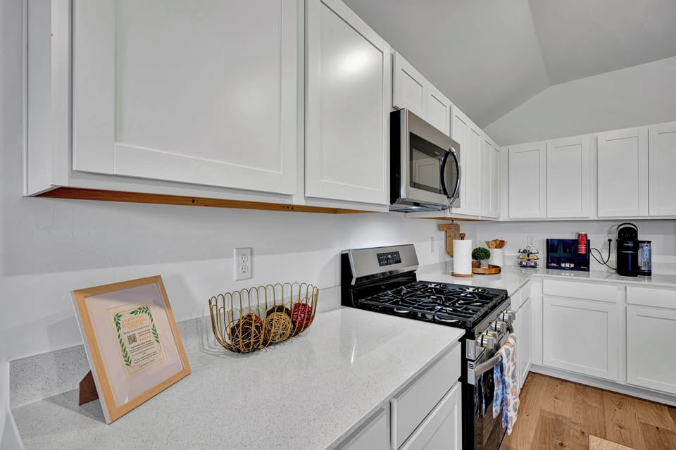 Kitchen counter and gas stove with stainless steel appliances