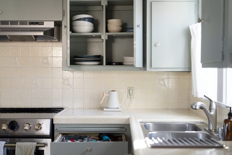 Plenty of tableware and cooking utensils.