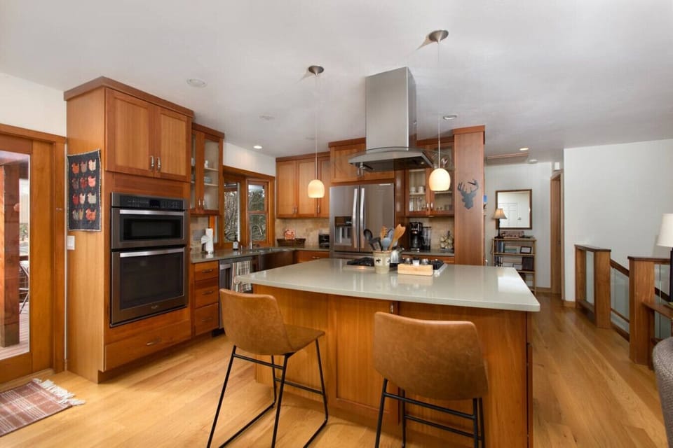 Kitchen Bar, large Island, and Stainless Steel Appliances