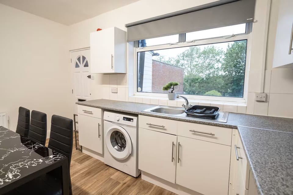Kitchen with Main entrance door in the background