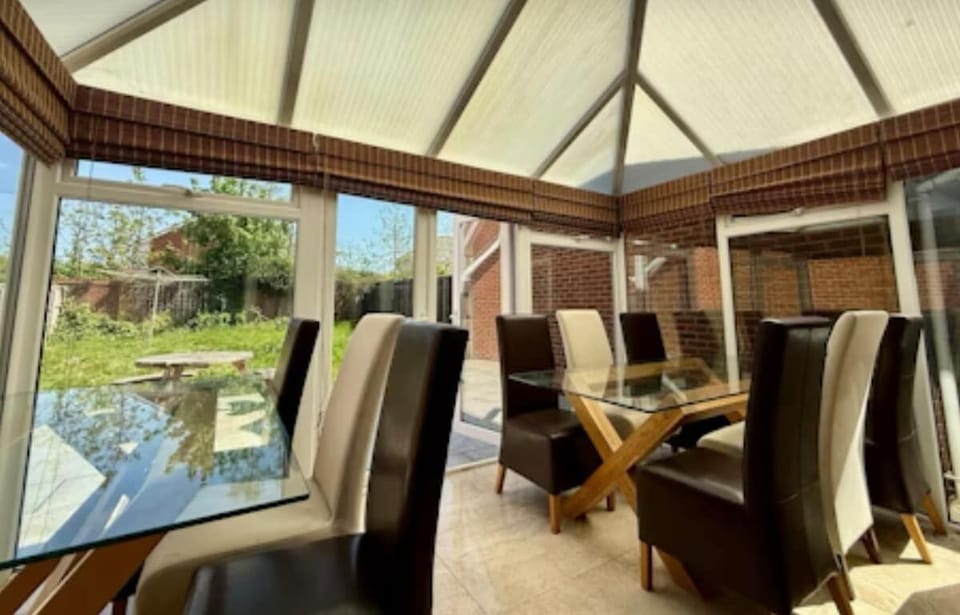 Updated photos pending
Conservatory dining space with full garden Vista 