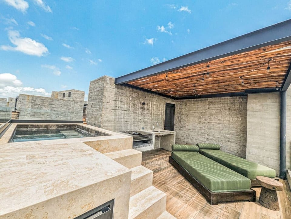 Relax above it all on the exclusive rooftop terrace featuring a private jacuzzi, sun loungers, and beautifully designed outdoor spaces perfect for soaking up the tropical atmosphere.