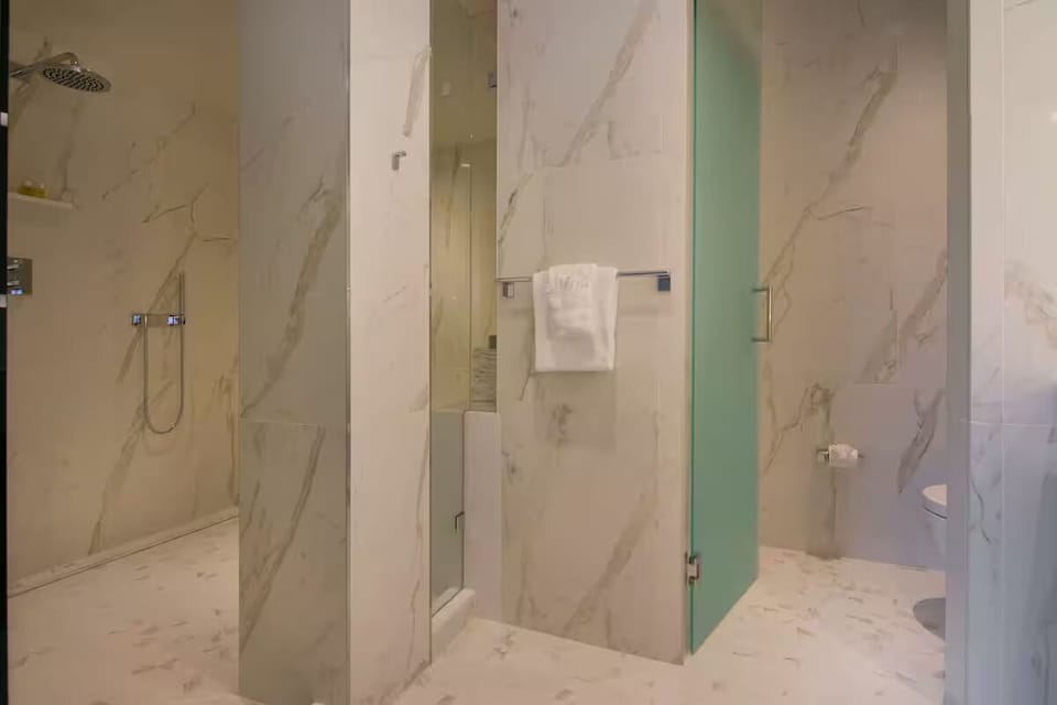 Refresh under a spa-like rainfall shower in sleek marble.