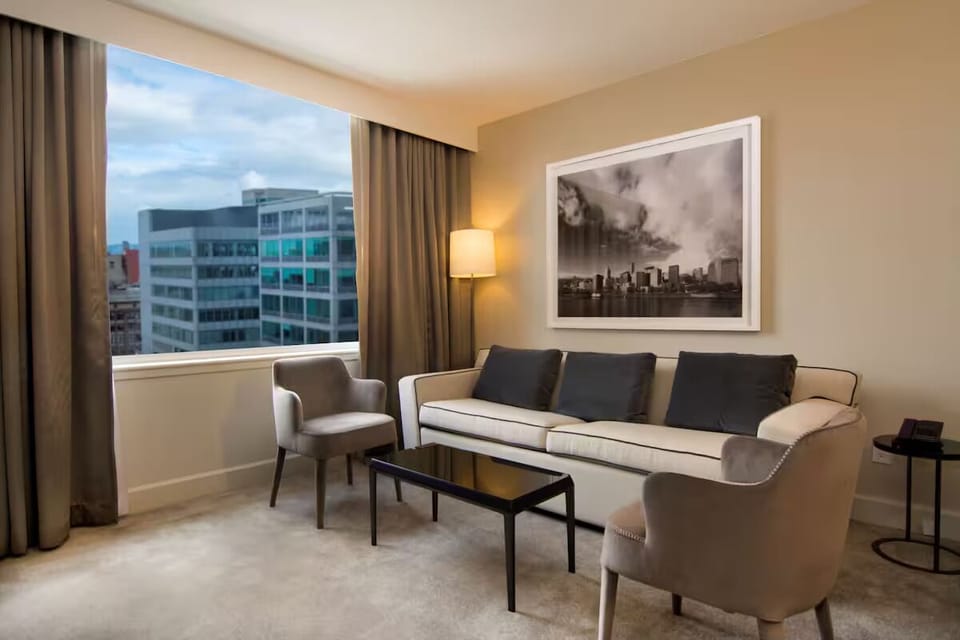 Unwind on the plush sofa beside expansive city views.