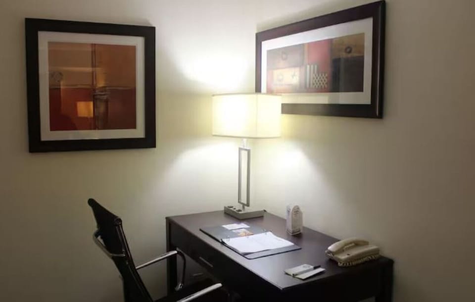 Catch up on emails at a quiet desk under warm light.
