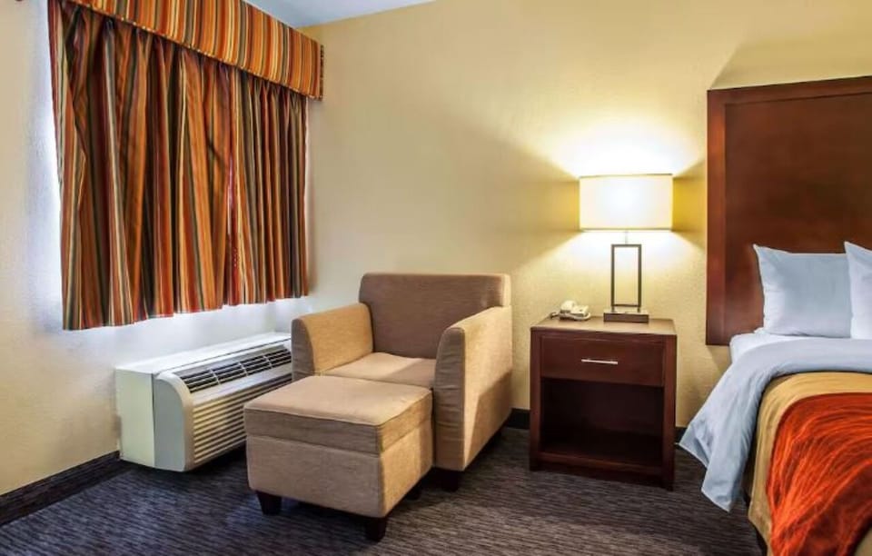Lounge by the window with a warm lamp glow.