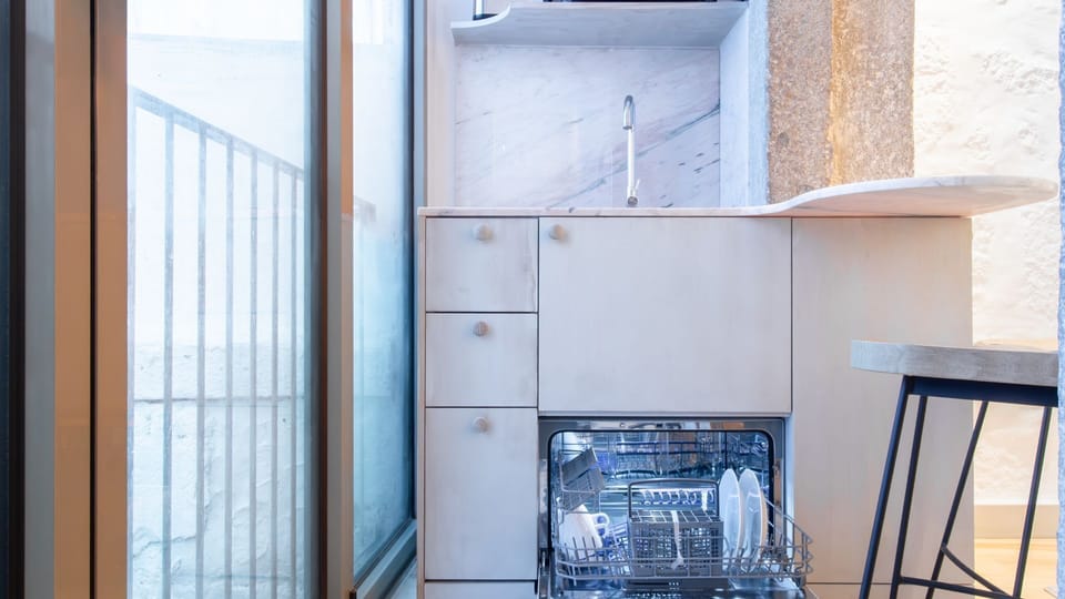 Modern kitchen with dishwasher and induction hob — designed for better stays. #ExtendedStay #FunctionalDesign #PortoAirbnb