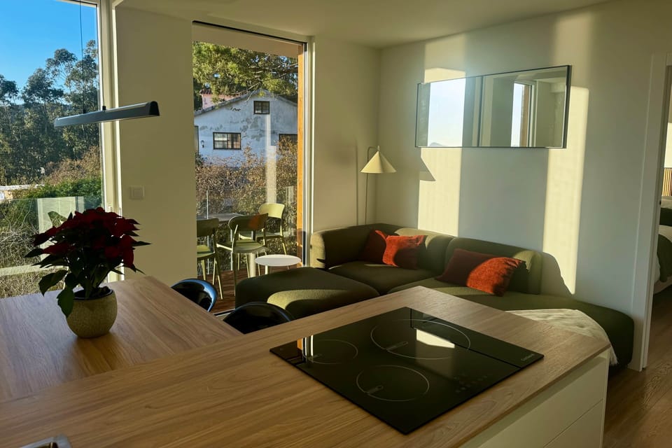 Cozy sofa corner to unwind as the sun sets over the sea and hills.