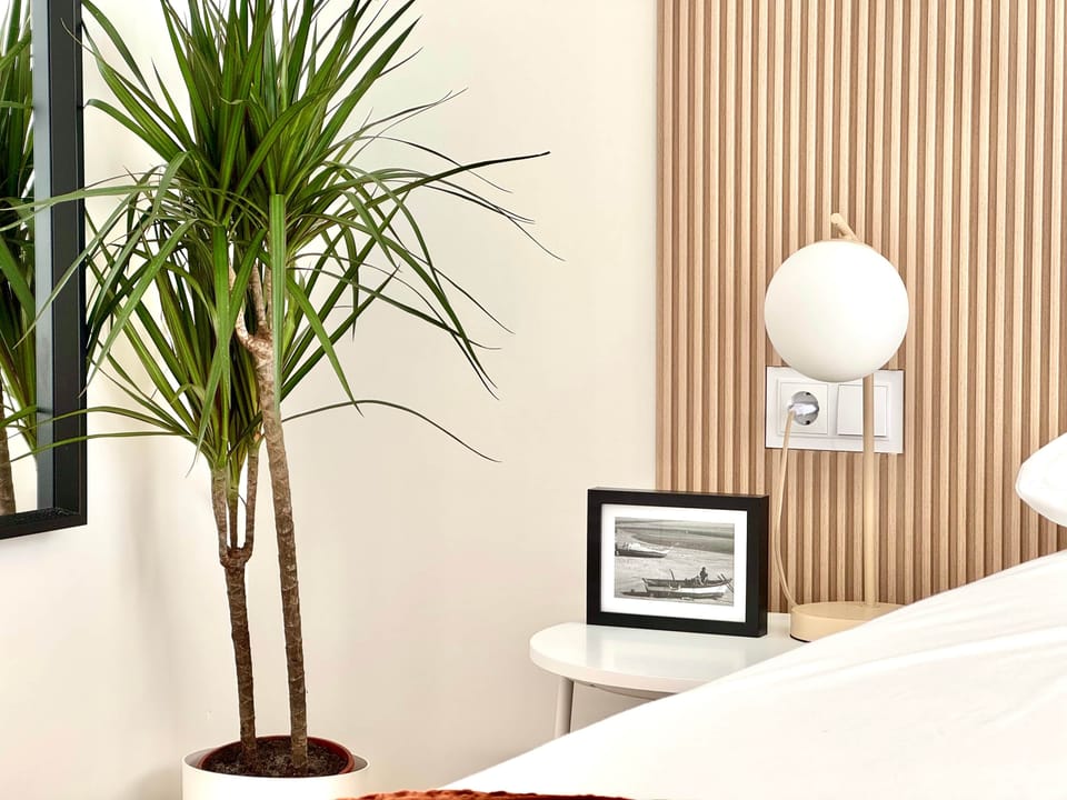 Natural textures and soft lighting bring calm to this cozy corner of the bedroom.