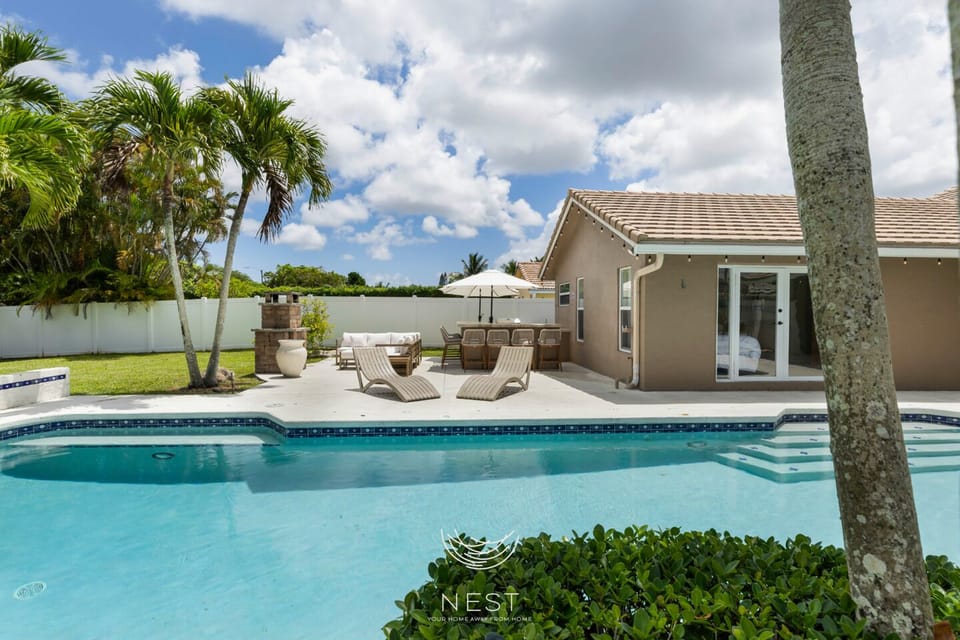 Spacious backyard oasis with a luxurious saltwater pool and pool cage for privacy.