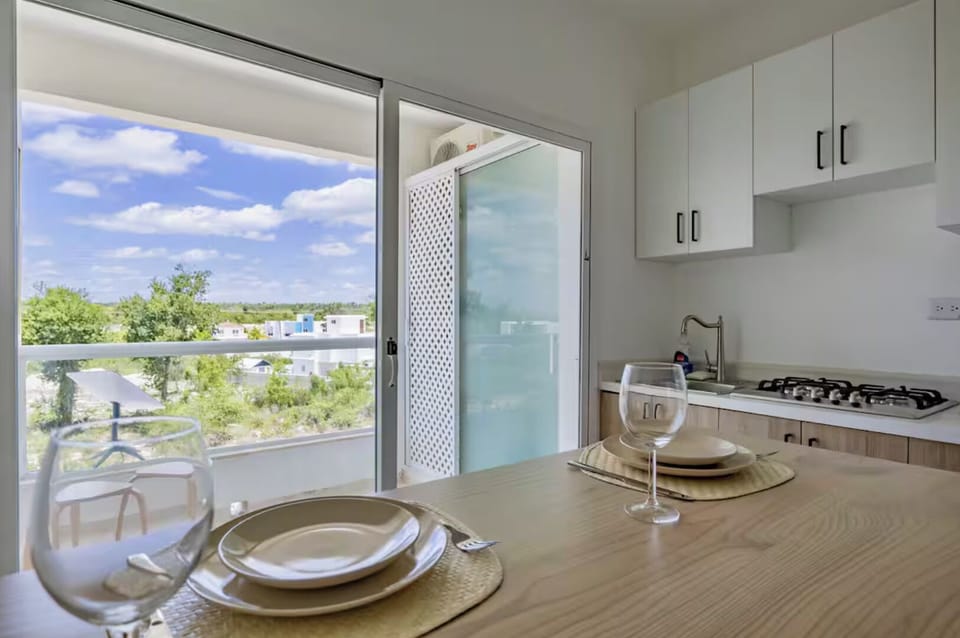 Fully equipped kitchenette with balcony access and natural light