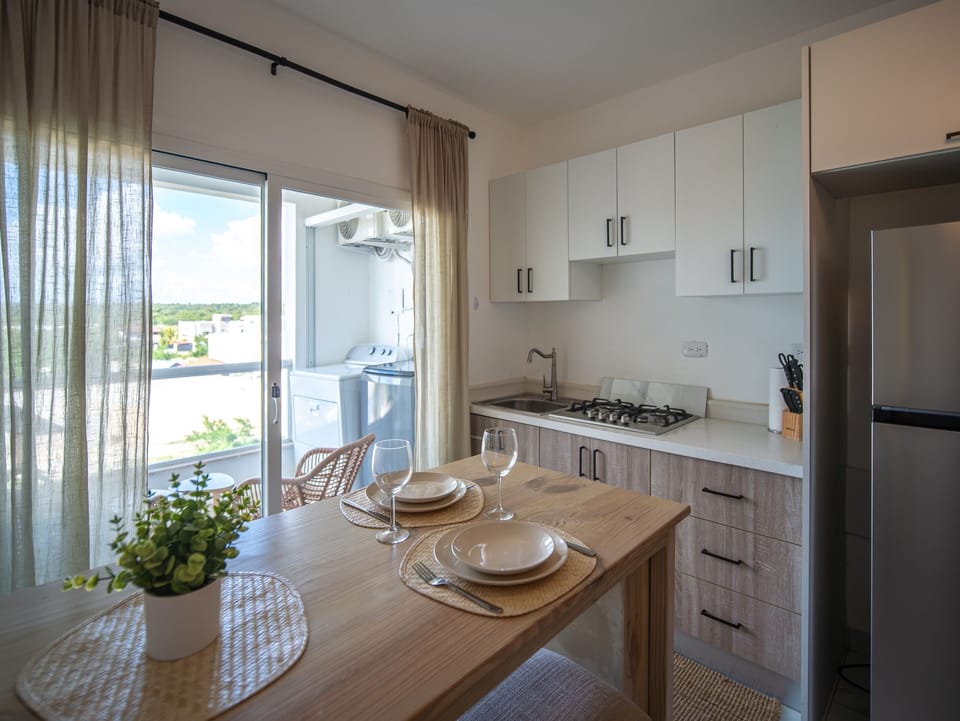 Kitchen + dining with balcony access, plus in-unit washer and dryer on the balcony.