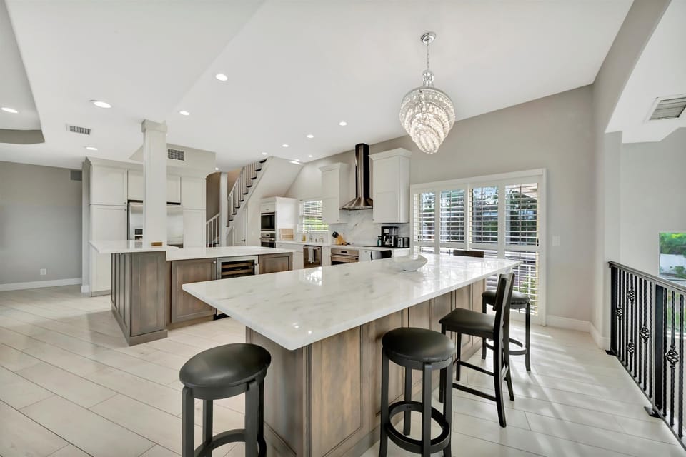 Luxury Kitchen with Quartz Island, Breakfast Bar, and Natural Light