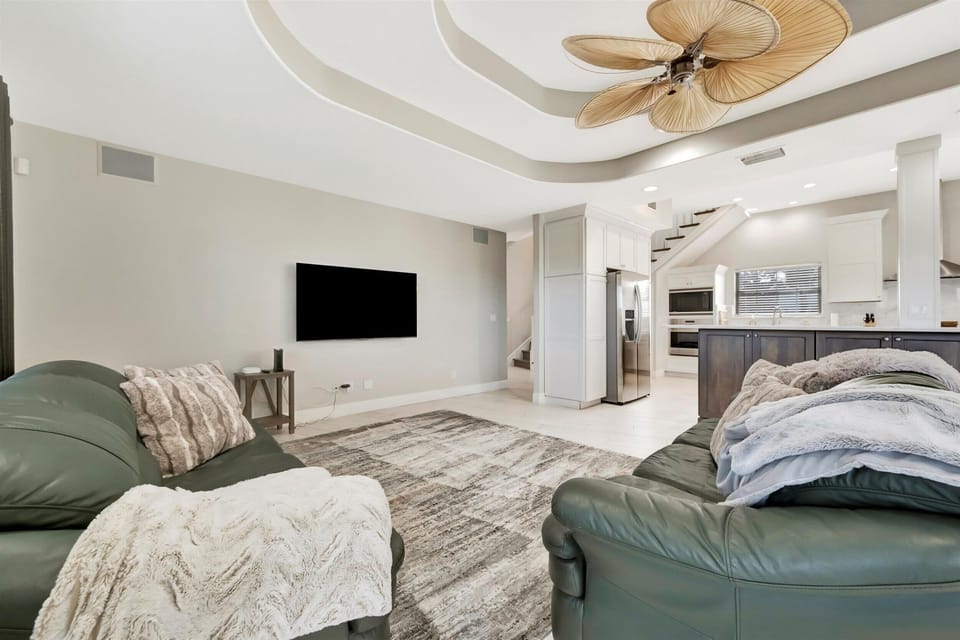 Open-Concept Living Area with Smart TV and Seamless Kitchen Flow