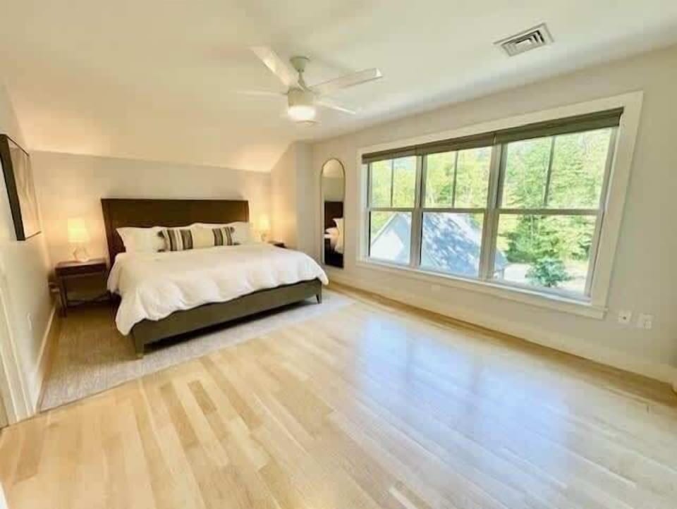Big windows, big comfort. Enjoy the serene surroundings from your cozy bed