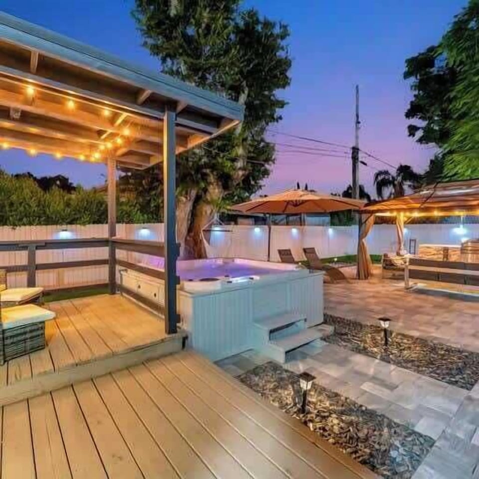Hot tub, cozy lighting, and ample outdoor space for ultimate relaxation