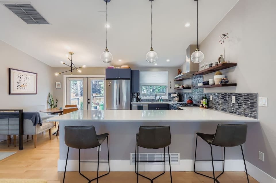 Enjoy a kitchen with three bar stools, combining functionality and style. Perfect for guests who like casual dining or gathering around the counter while cooking.