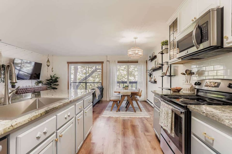 Kitchen with open view to living room and dining table with your choice of seating 