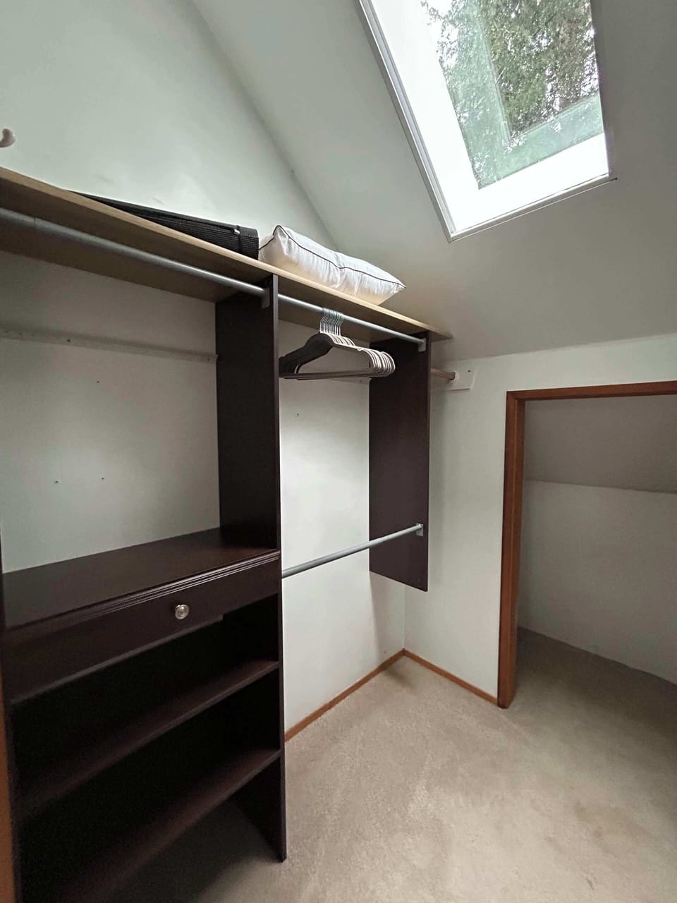 Primary bedroom closet.  Lots of storage and luggage rack.