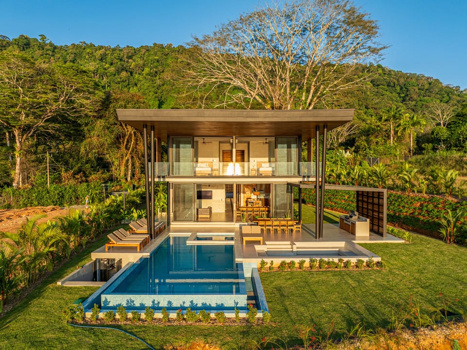 Overview of back of house with beautiful pool and hot tub