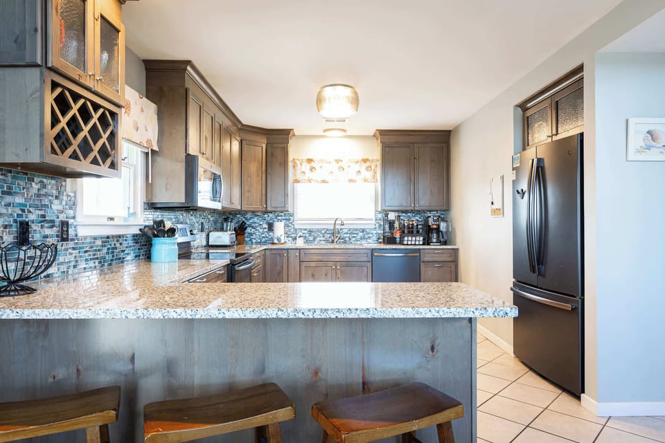 Top Level: Fully Stocked Kitchen w/ Refrigerator, Dishwasher, Toaster, Oven, Microwave, Stove, Toaster, and Cooking Utensils with Breakfast Bar