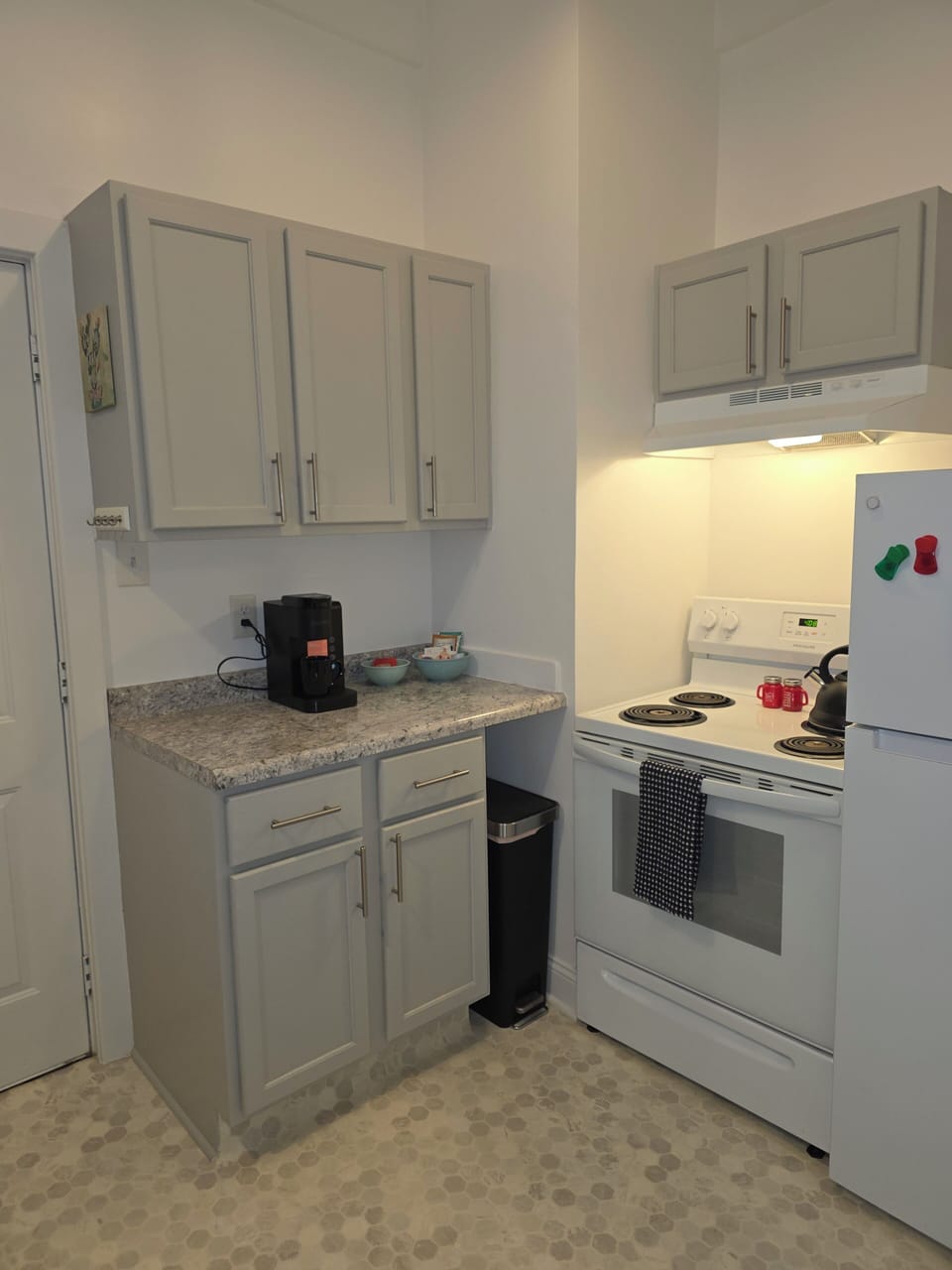 Full kitchen with Keurig, tea kettle, cooking supplies, coffee/tea supplies.