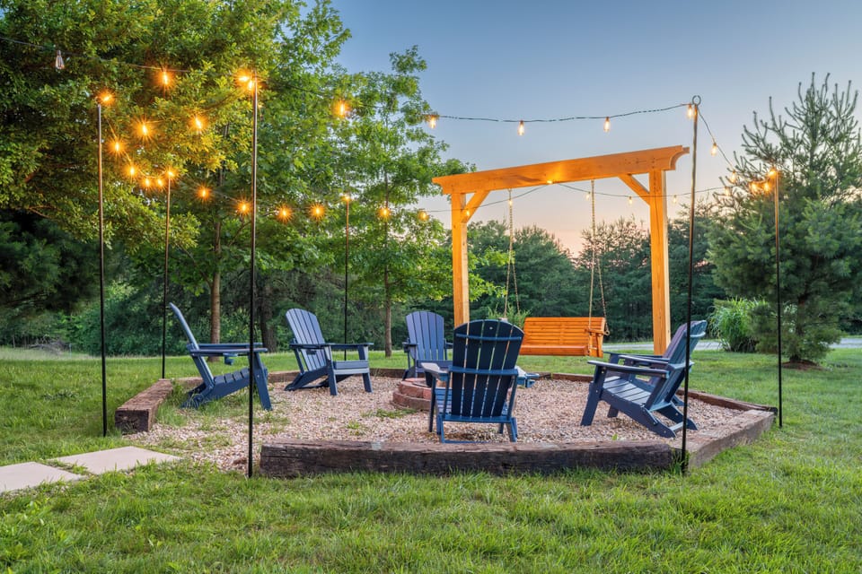 Gather around the fire pit under the warm glow of the string lights.