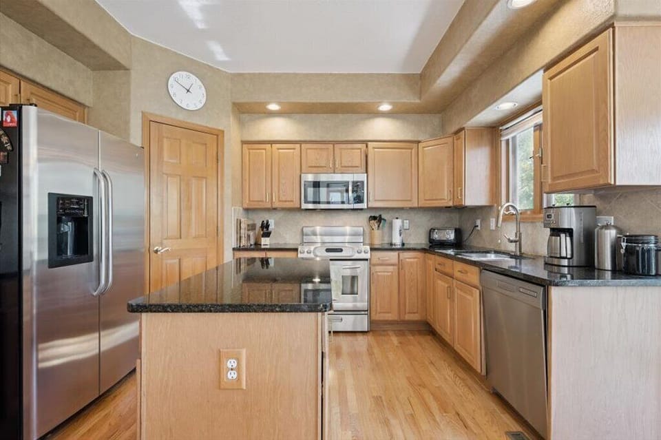 Full kitchen with stainless appliances and granite counters