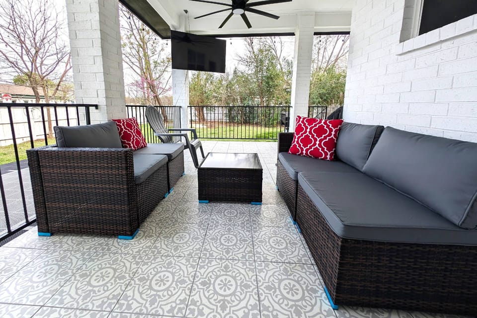 Louge on the covered patio next to the basketball court and propane BBQ grill