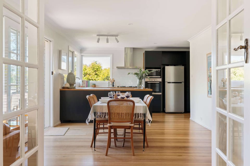 Step through the living room glass doors into the open dining and kitchen area