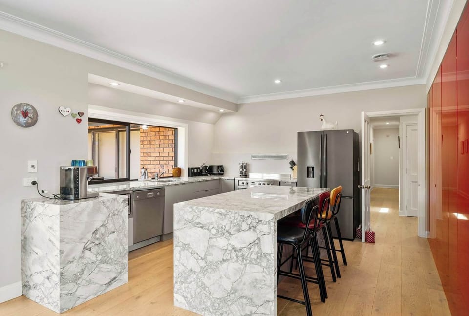 The house features an entertainer's kitchen with full granite bench-tops, a coffee machine, double fridge, an over sized oven and of course a dishwasher.