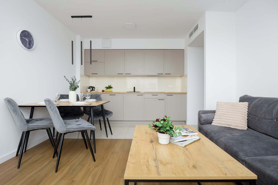 The bright space with a large table encourages relaxed meals and focused work, giving guests a comfortable spot to enjoy their stay.