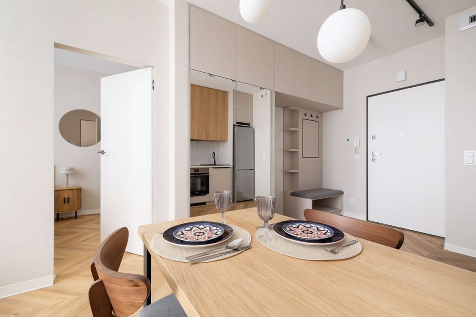 A bright living room with a dining table. 