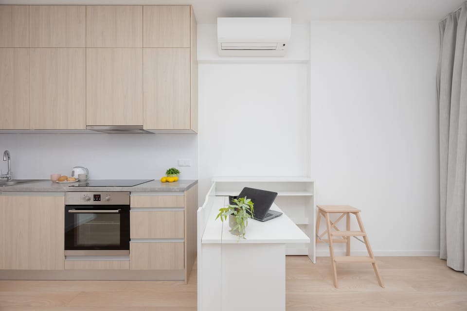 Another view of the kitchenette with a countertop and minimalist decor. The space feels clean and functional for preparing meals.
