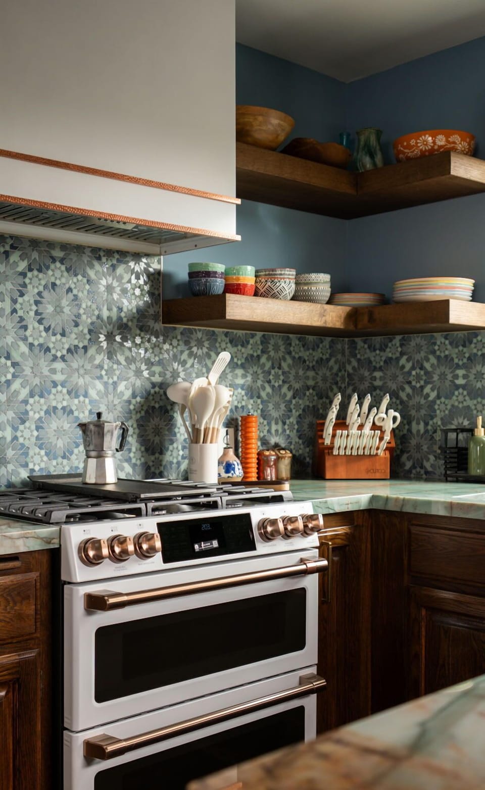 Warm wood, patterned tile, and modern finishes bring depth and personality to this well-equipped kitchen.