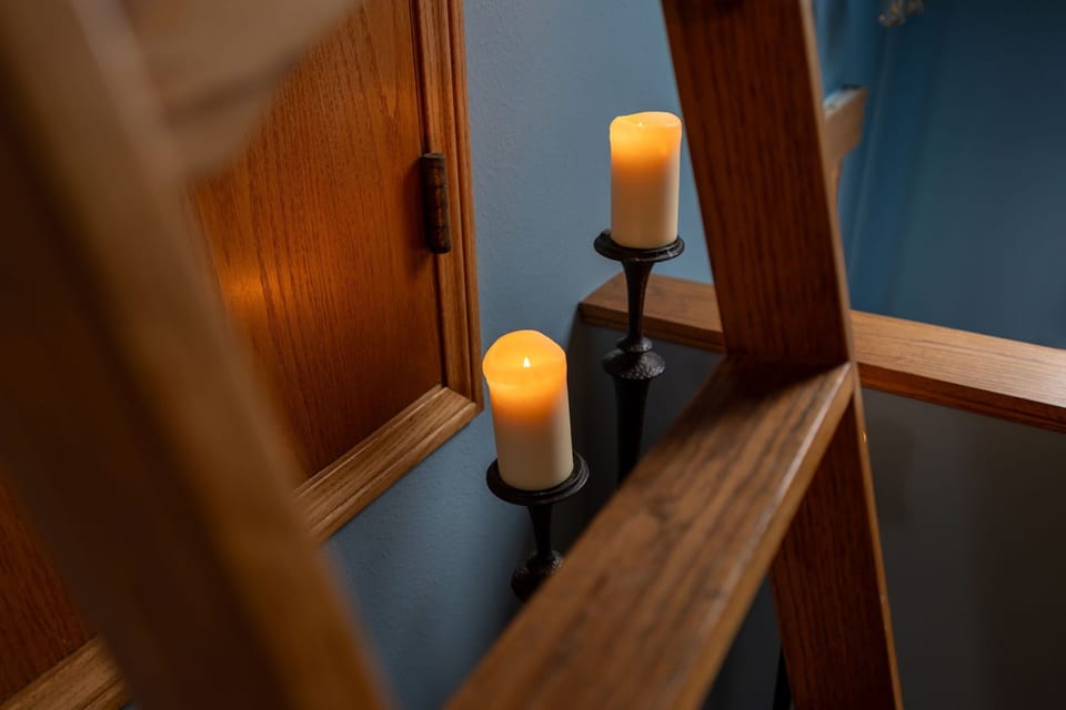 A soft candlelit detail that brings a gentle glow and warmth to the hallway.