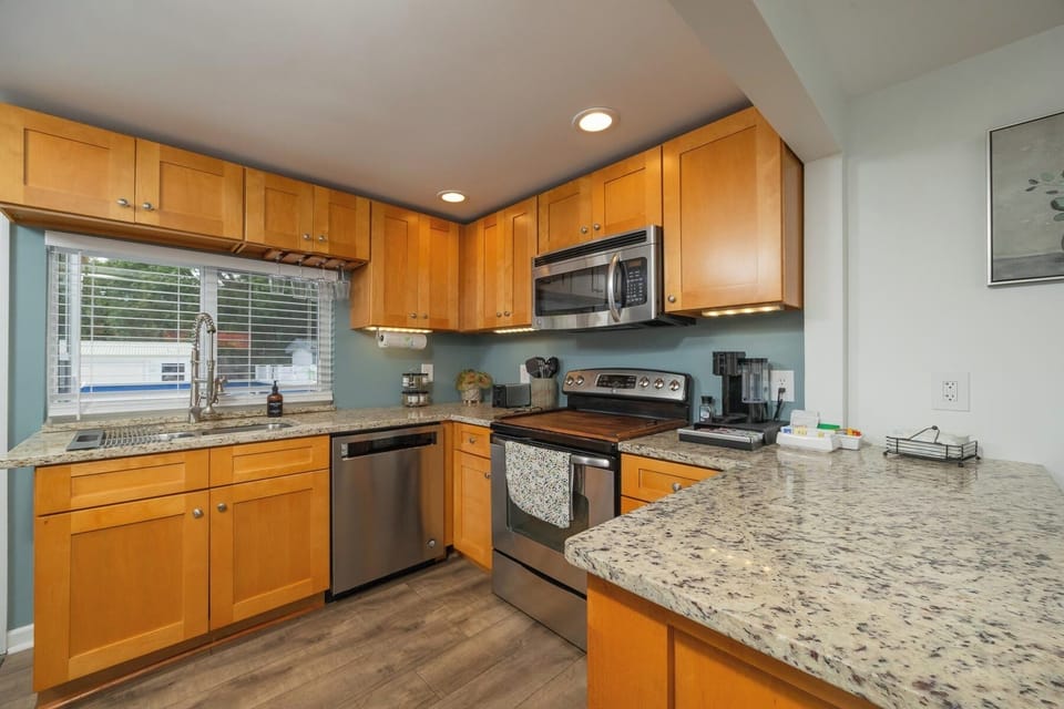 Bright modern kitchen with granite counters and stainless appliances
