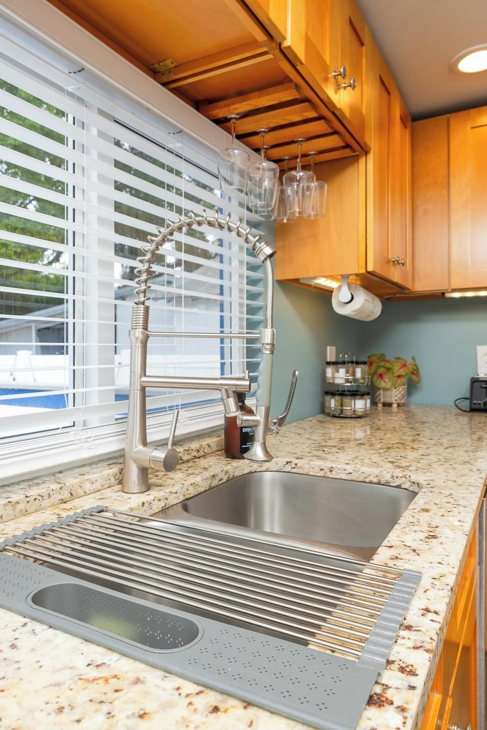 Bright kitchen with granite counters, deep sink, and upscale faucet