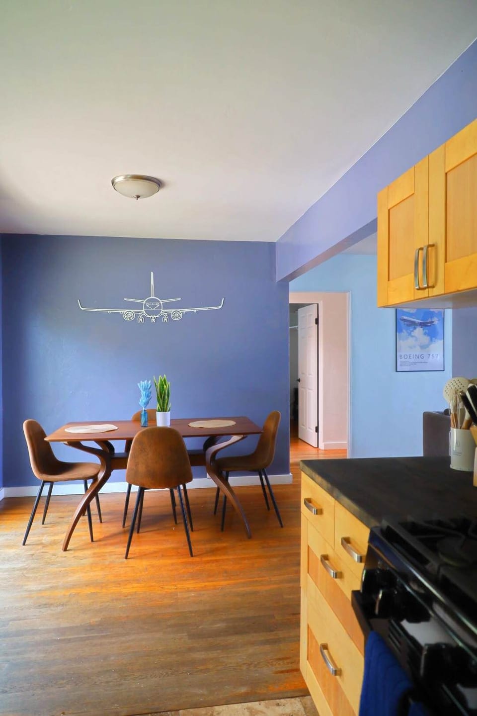 Bright, cozy dining space with natural light, warm wood floors, and an open kitchen, perfect for relaxing meals and feeling right at home.