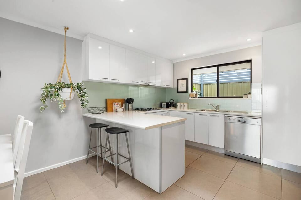 The breakfast bar with comfortable stools offers a convenient spot for quick bites between beach outings.