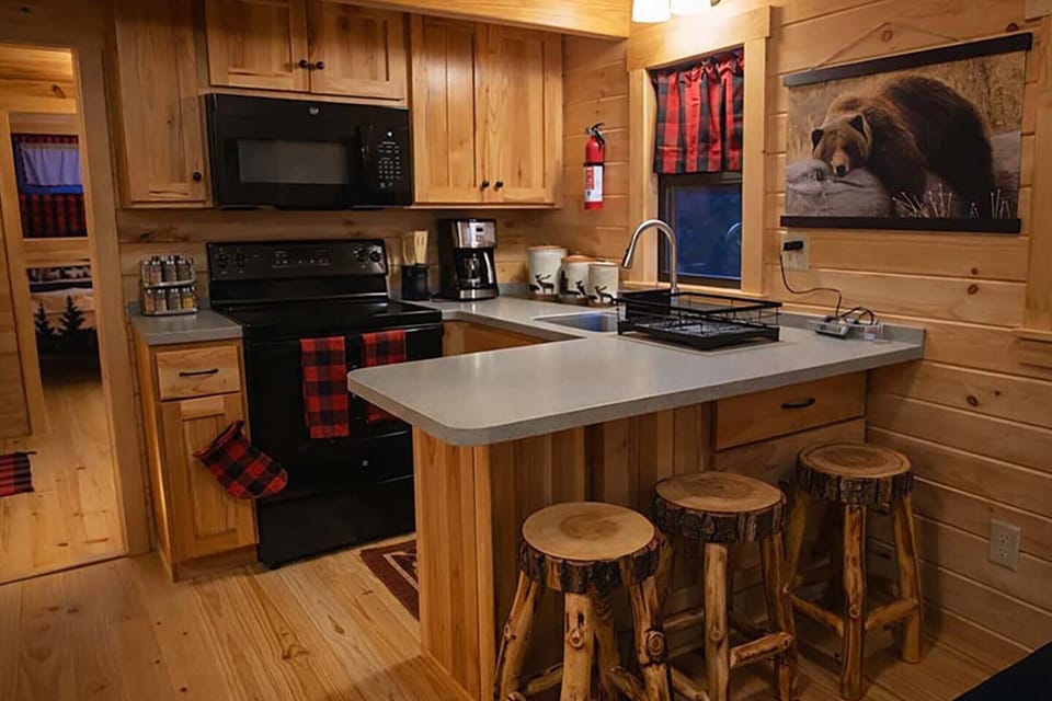 “Fully equipped rustic kitchen stainless steel cookware & inviting cabin warmth.