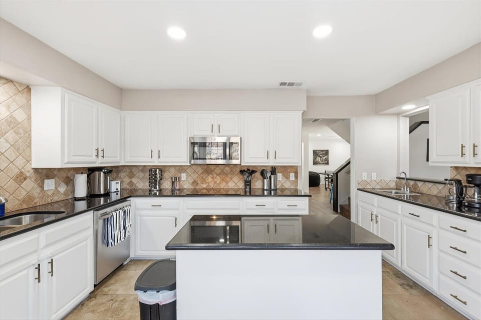 Spaciously laid out with a center kitchen island and plenty of countertops, this dream kitchen looks like it waltzed off the latest HGTV show!