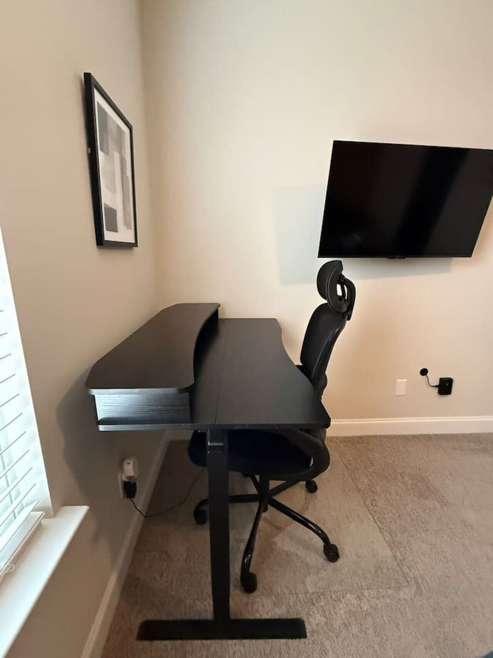 Enjoy a dedicated workspace within the bedroom, featuring a standing desk and an ergonomic chair to keep you comfortable and productive.