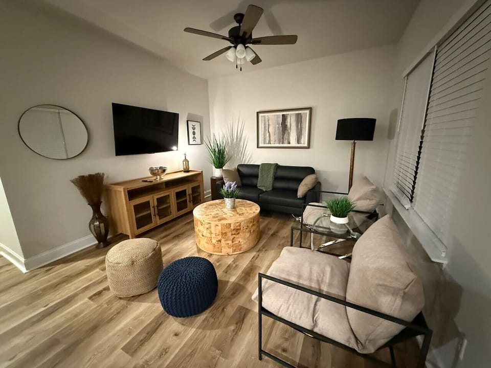 Cozy, modern retreat with warm wood floors, comfy seating, and a perfect setup for relaxing nights in.