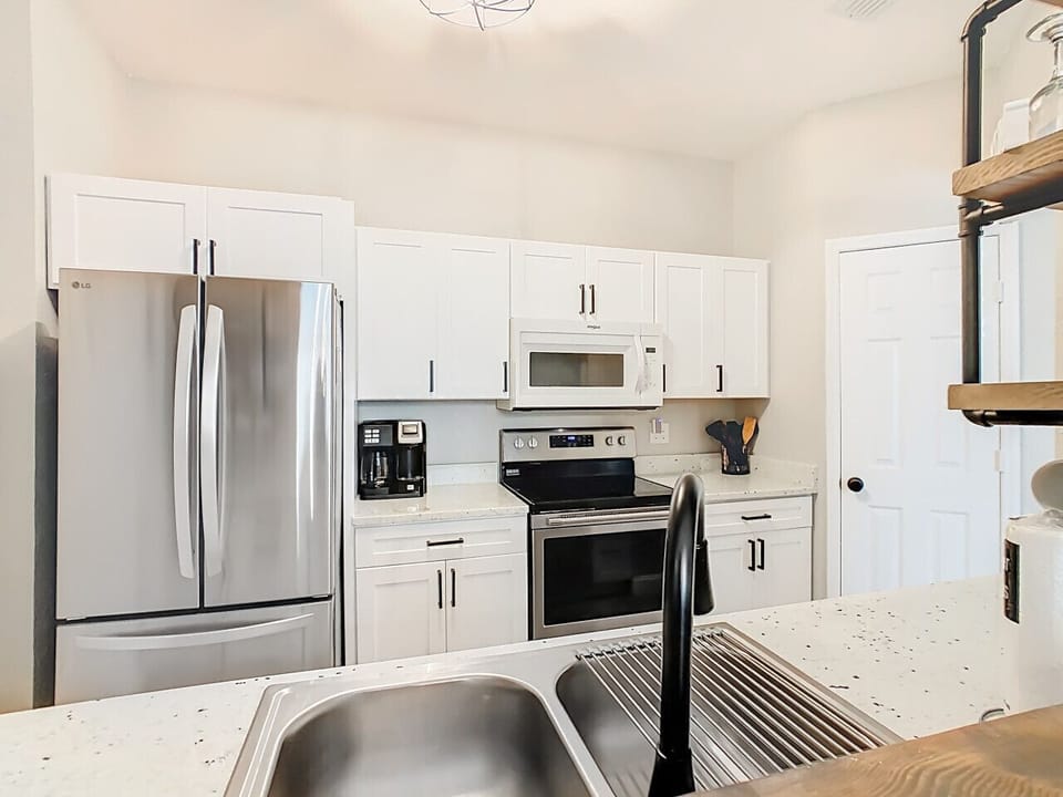 Fully equipped kitchen with stainless-steel appliances, granite countertops, and plenty of cabinet space.