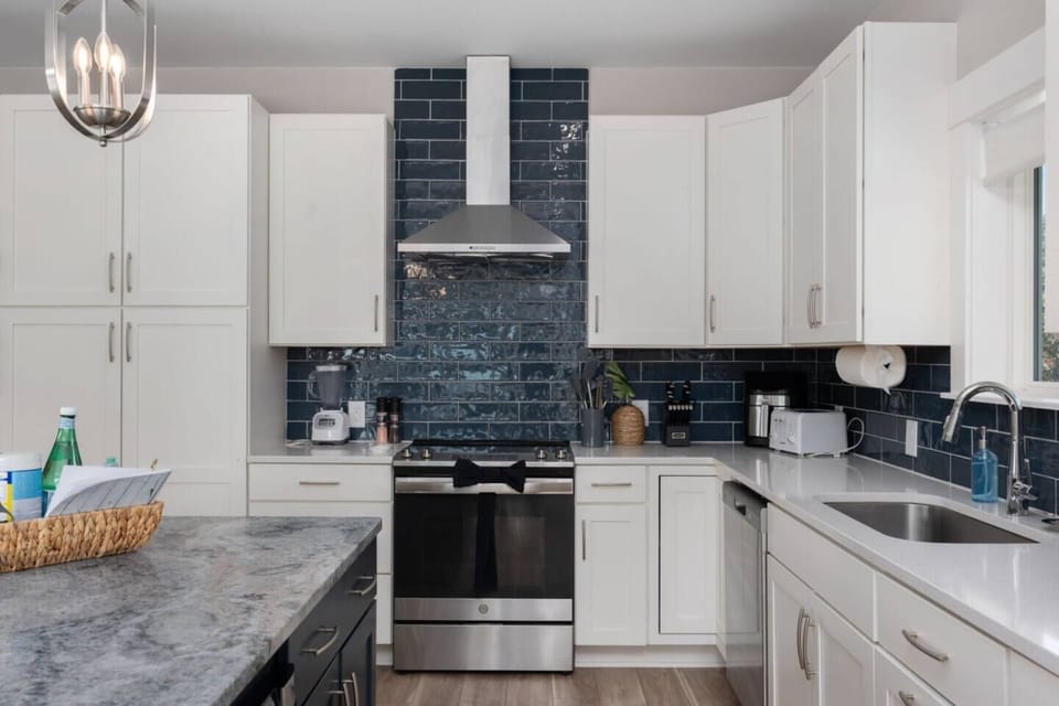 Clean, modern kitchen w/ sleek cabinetry, island seating & space to cook together.