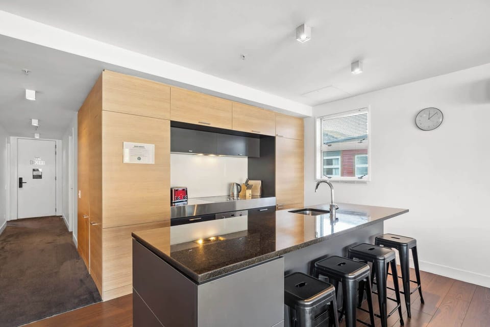 Fully equipped kitchen featuring modern appliances and bar seating.