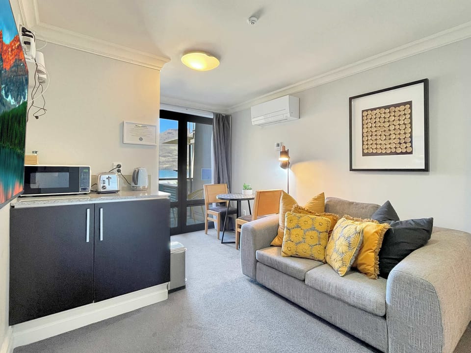 Open-plan living and kitchenette area with comfortable seating, ideal for relaxing between adventures.