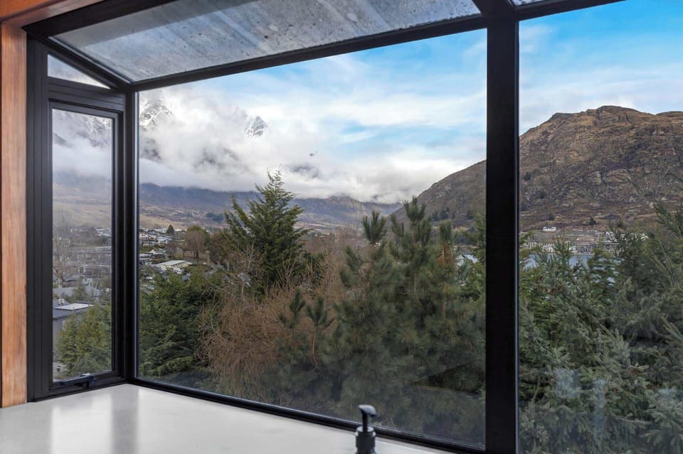 Kitchen sink view overlooking mountains and lake