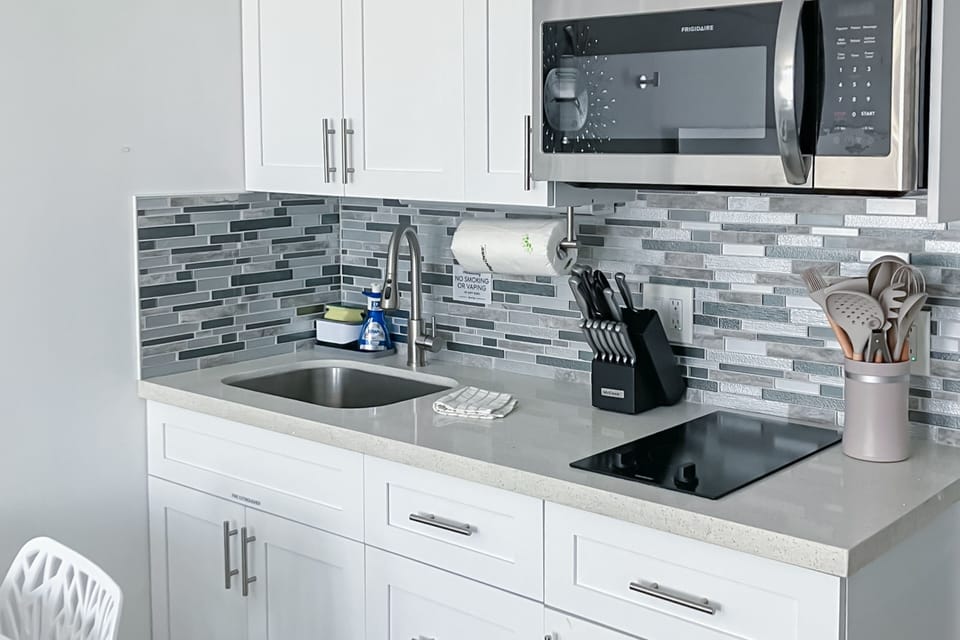 Sleek kitchenette with stainless appliances and coastal accents—perfect for prepping meals during your beach stay. Bright, clean, and fully equipped for a relaxing oceanside getaway.